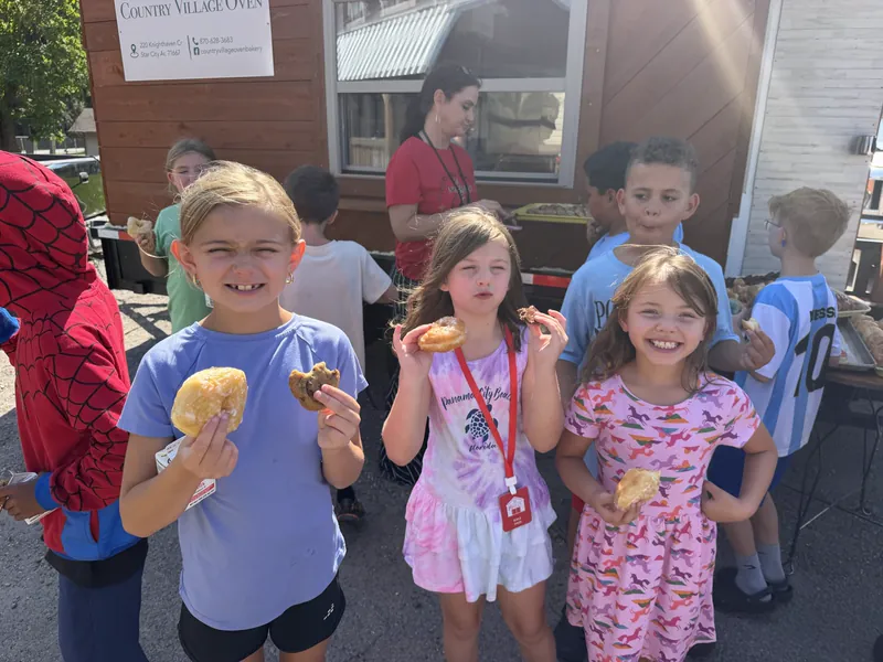 Students outside holding cookies they decorated
