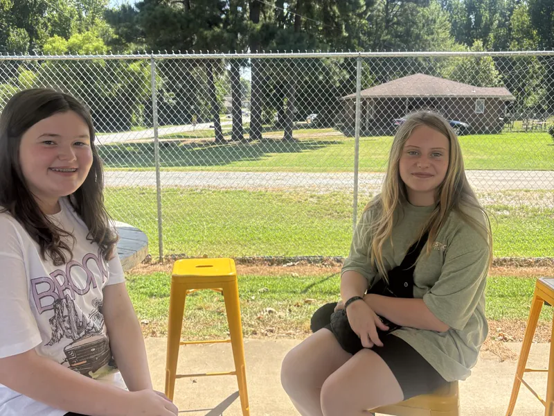 Two students outside at the start of the day