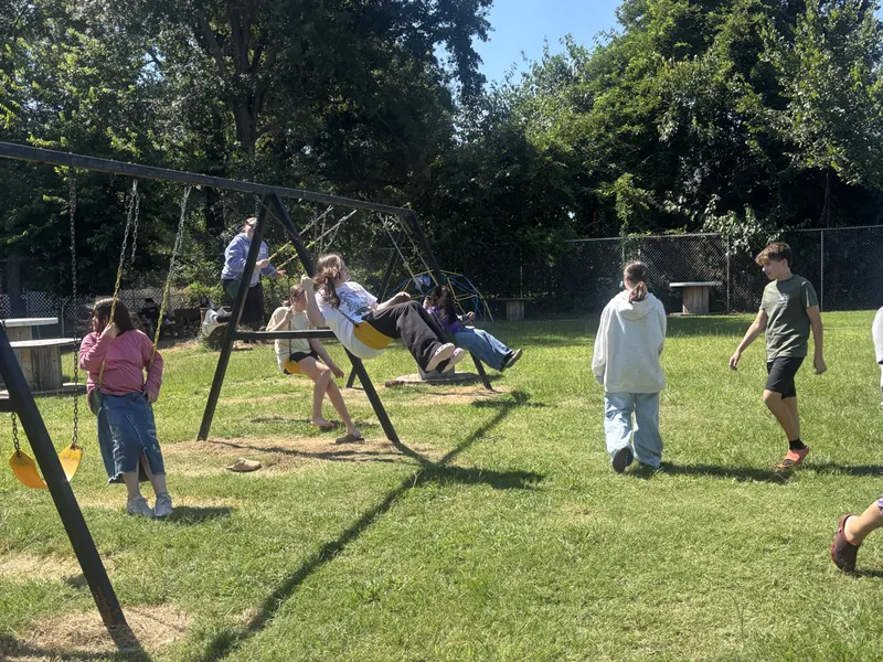 Students playing on the field behind the school