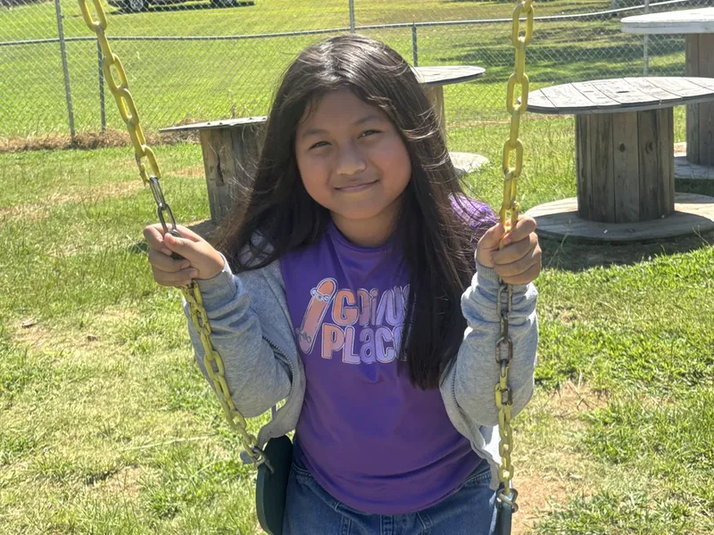A student on the swings at break time