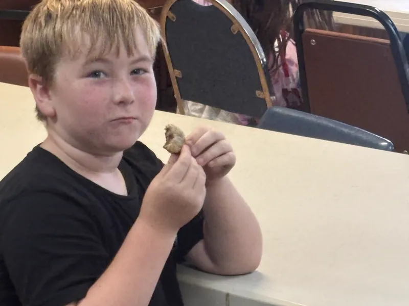 A student trying a cookie made in class
