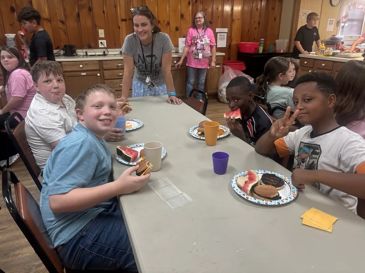 Students eating lunch together around a long table